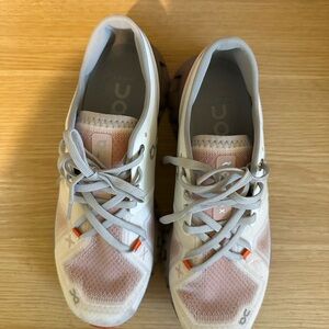 On Running White and Orange Athletic Shoes
